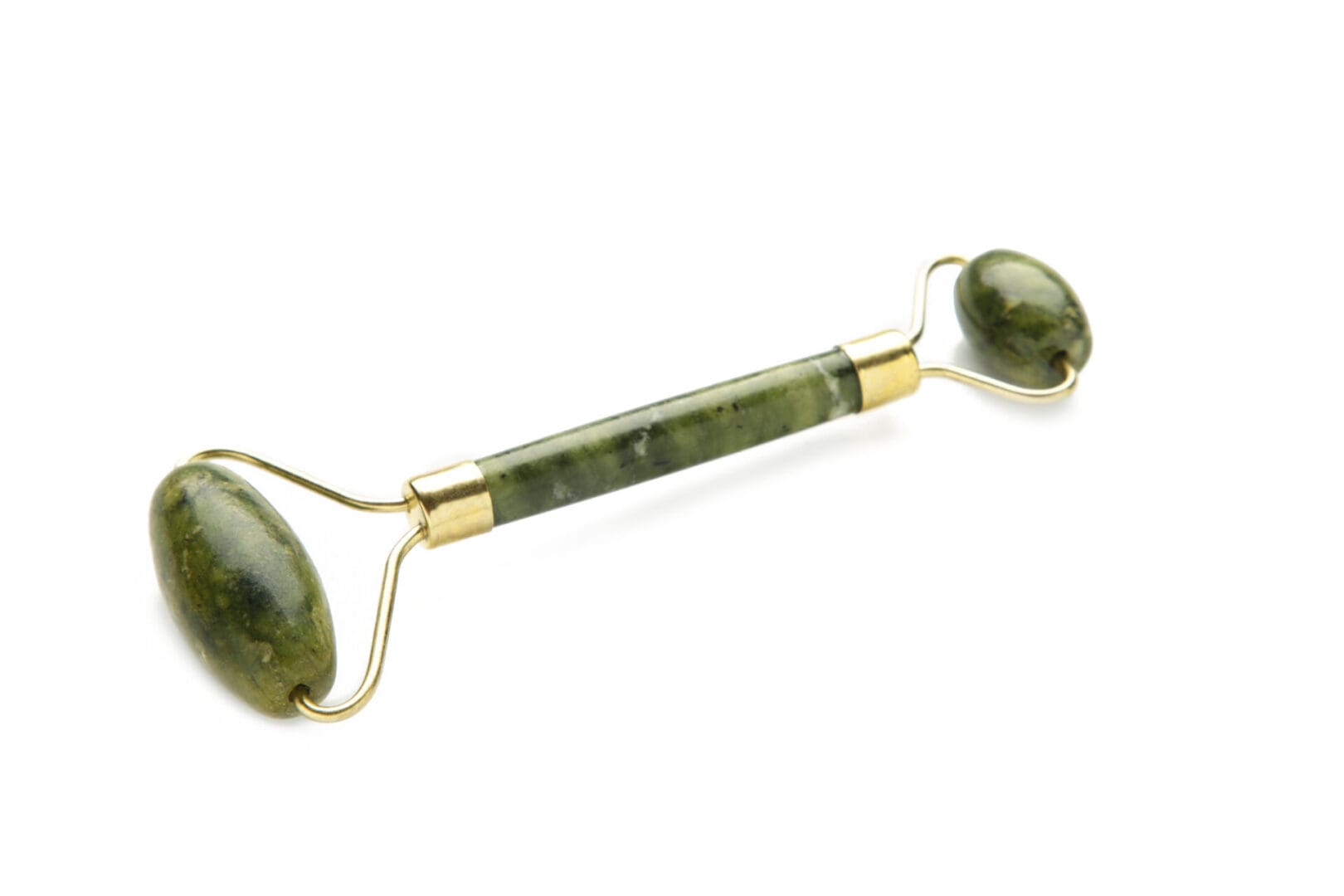 A green stone roller with two balls on it.