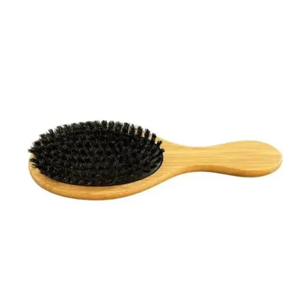 A wooden brush with black bristles on top of it.