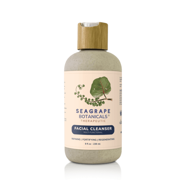 A bottle of facial cleanser on a green background