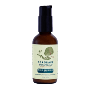 A bottle of sea grape botanical oil on a green background.